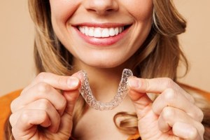 Woman holding clear braces